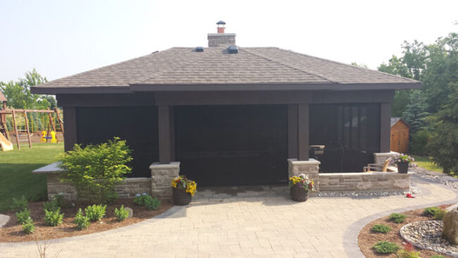 Black motorized privacy screen installed on a mondern cabana