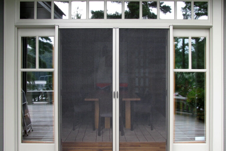Sliding glass doors with mesh screens leading to a patio area.