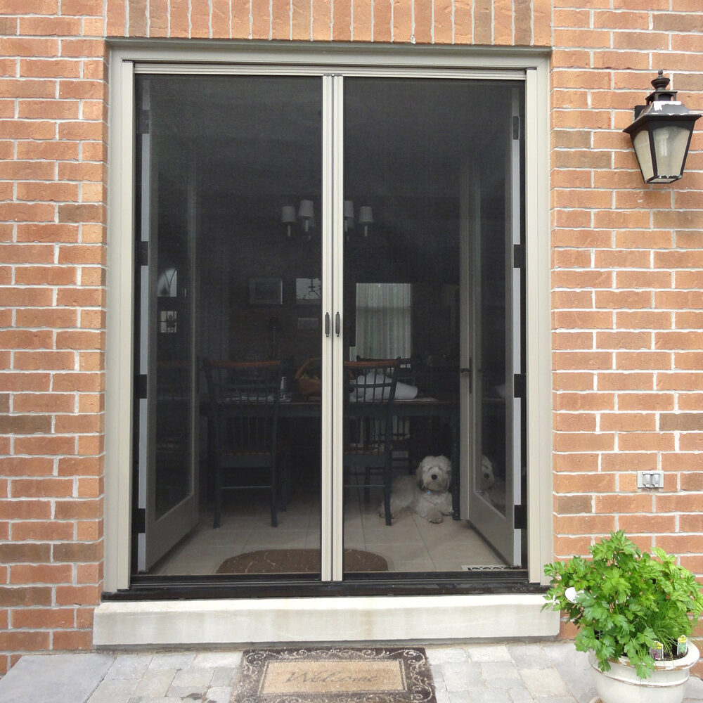 Open glass doors leading to a cozy indoor seating area with brick walls.