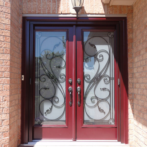 Elegant double wooden doors with ornate wrought iron designs and glass panels.