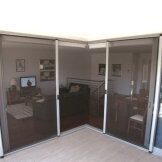 A corner patio with sliding glass doors leading indoors.