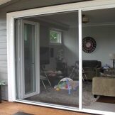 Sliding glass door leading to a cozy living room.