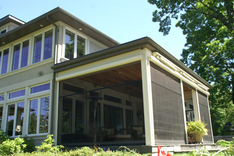 Modern house exterior with large windows and screened porch.