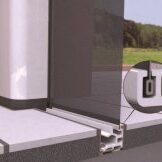 Close-up of a sliding glass door track and frame installation.