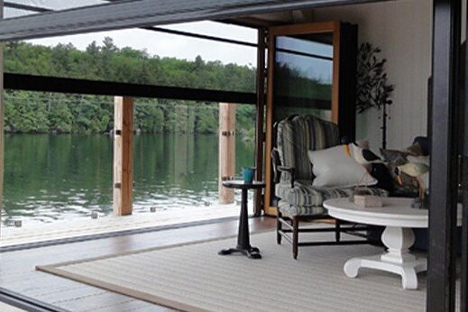 Cozy lakeside porch with comfortable seating and scenic water view.