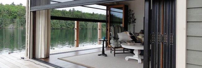 Cozy lakeside porch with comfortable seating and scenic water view.