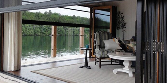 Cozy lakeside porch with comfortable seating and scenic water view.