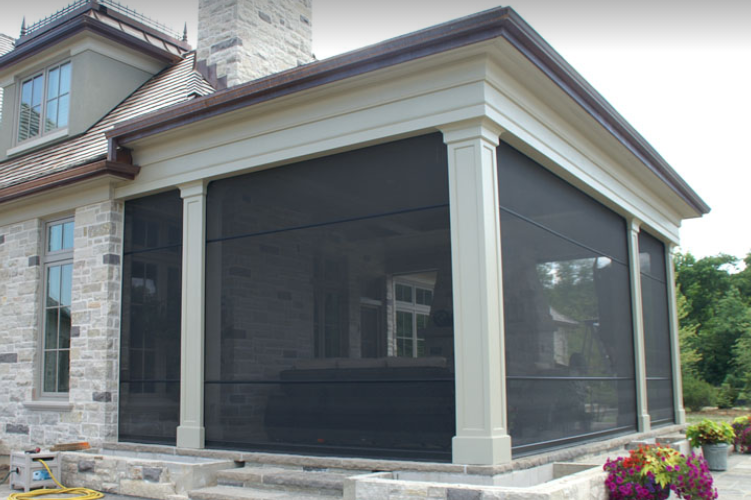 Modern porch with retractable black mesh screens and stone base.